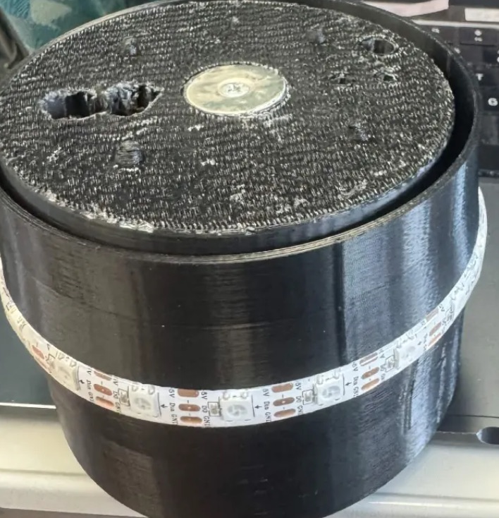 The assembled SipSync base: a 3D-printed cylinder with the load-cell platform on top and an addressable LED strip around the body